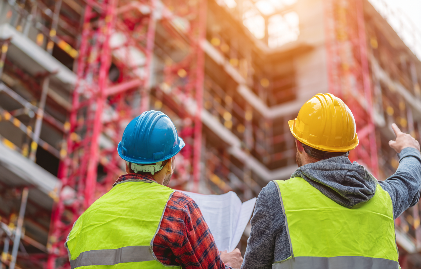 jay081480_77365_two_male_construction_workers_in_yellow_and_gre_46780385-0f0c-4bcc-9fb4-2f54dcf47abb